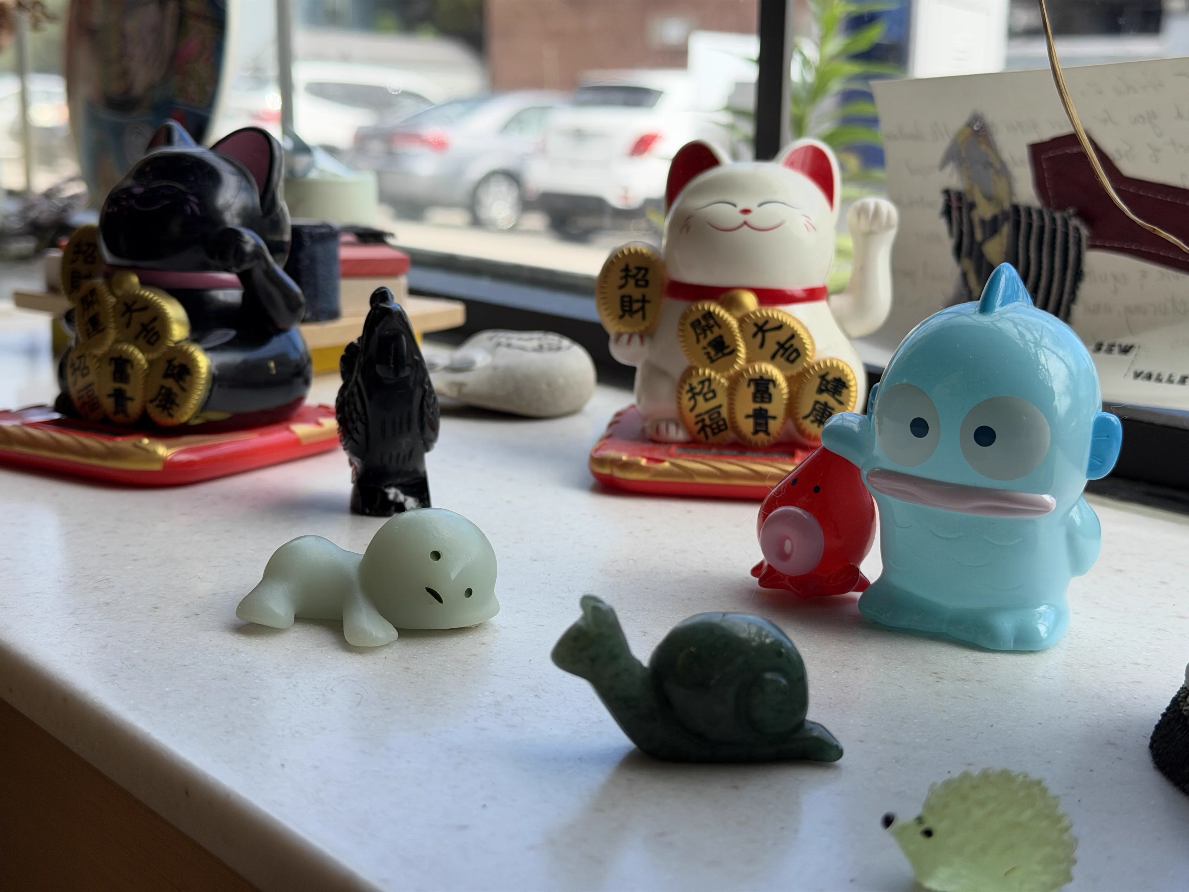 Figurines displayed by the window at Kiki on Ludlow